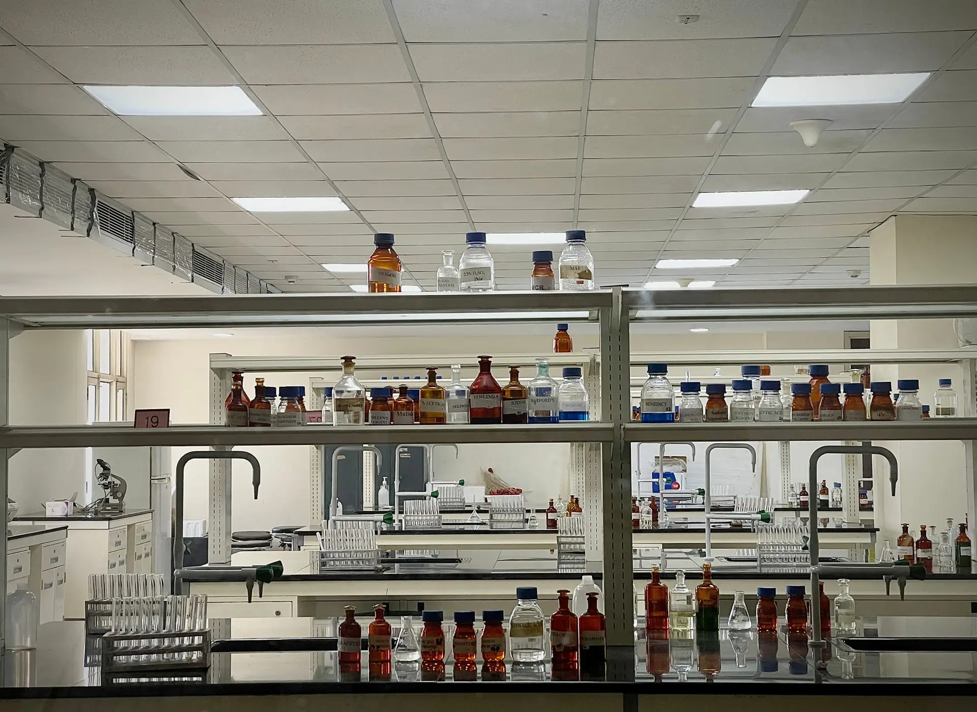 A detailed view of a modern science lab with chemical bottles and test tubes.