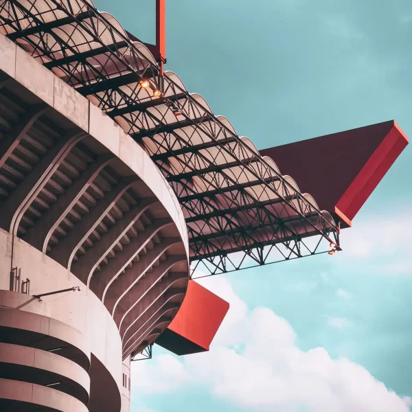 A low-angle view of the iconic San Siro Stadium in Milan, Italy, showcasing its distinctive architecture.